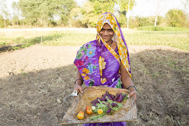 Women farmer displaying freshly picked produce