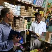 Two business men talking in a grocery store