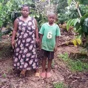 As Coffee farmers face the COVID-19 Crisis worldwide, Biringwa is no exception. Featured here, she stands with her son on their farm in Uganda
