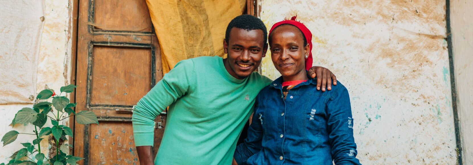 Lubaba Mekonnen (right) and her son, Mohammed Jamal, outside their house in Ethiopia’s Jimma zone. (TechnoServe / Olivia Sakai)