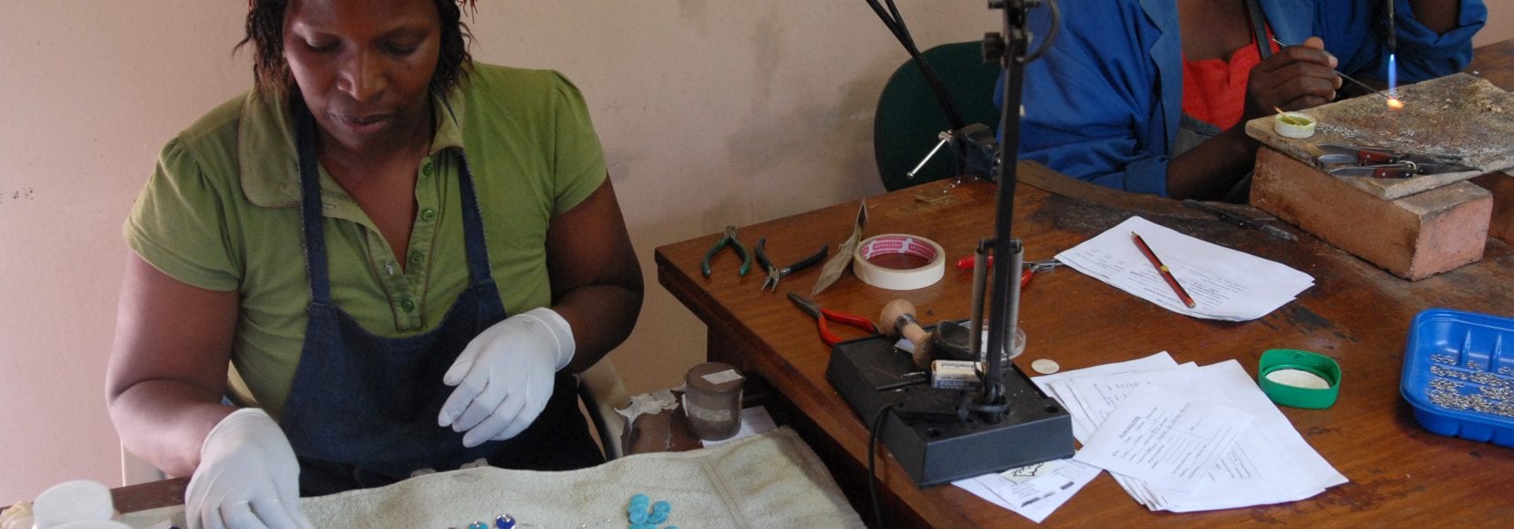 Two women working on jewelry