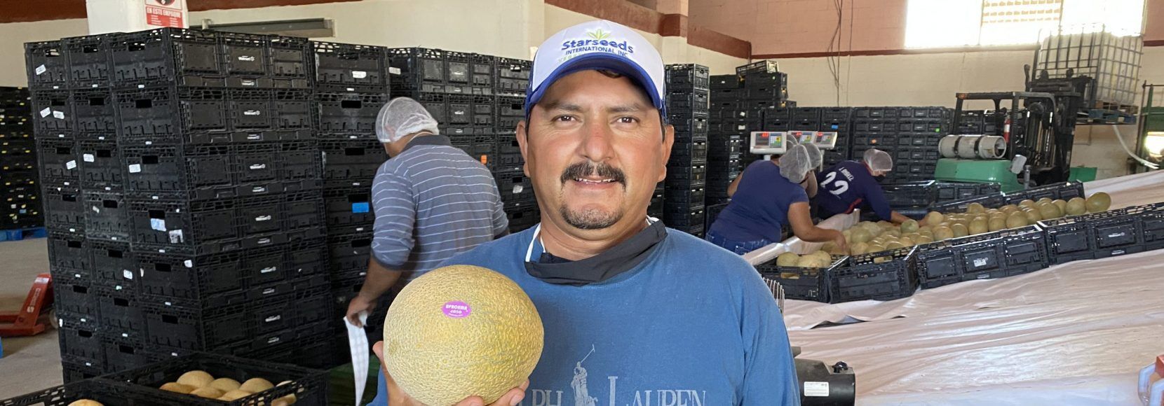 Eloy Castañón holds a melon in a processing facility in Mexico