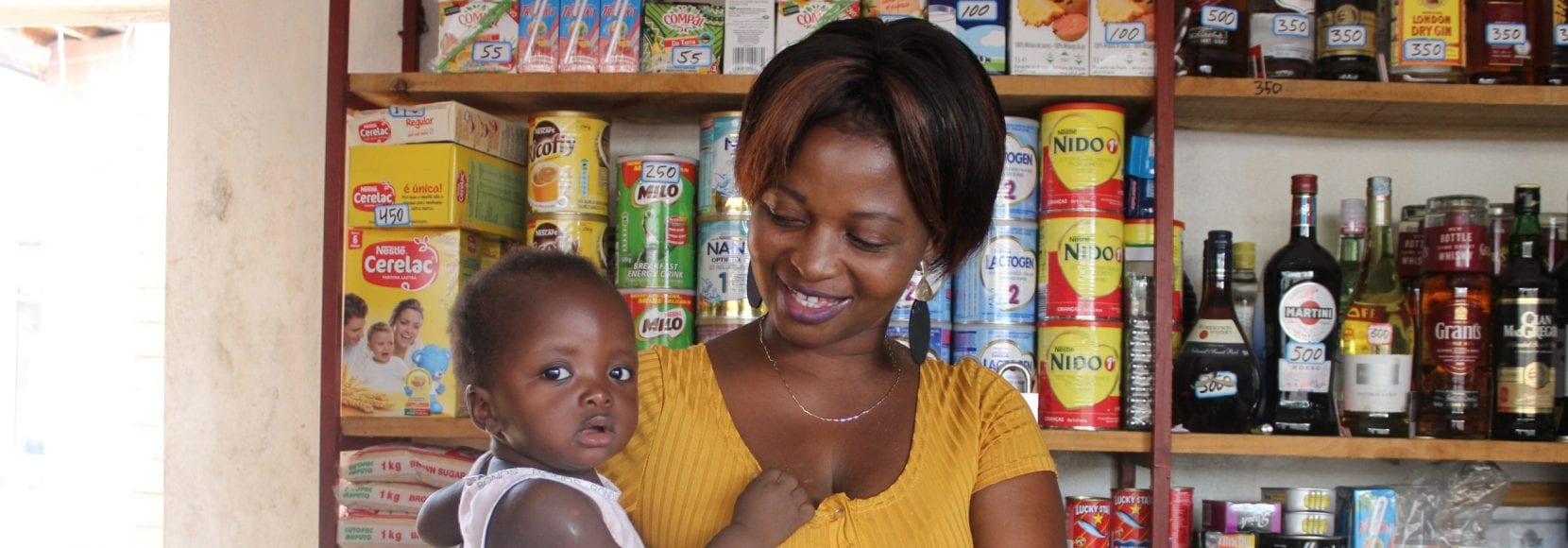 Bernadette Sambo stands in her shop in Mozambique.