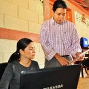 Two people working on laptop