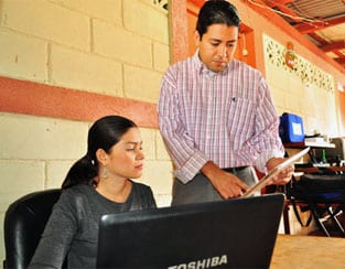Two people working on laptop