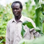 Farmer smiling walking through crops