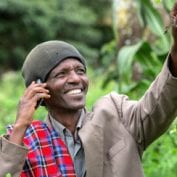 Man smiling while talking on the phone