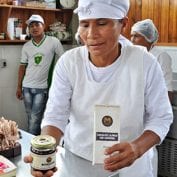 Cook holding out jar and bag