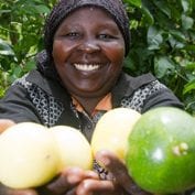 Woman smiling with hands full of produce