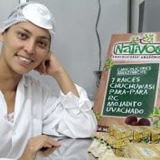 Woman smiling while processing food