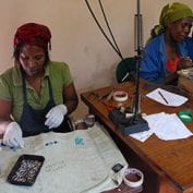 Group of women working to create jewelry