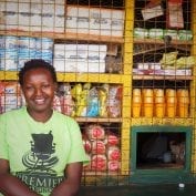 Woman smiling in front of food in Kenya