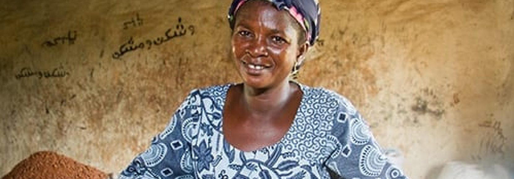 Damata Shihadu, 39, feeding ground shea nuts into pulper, Nyebu Be Yoona Shea Butter Processing Group, Kanfiehiyili village, Tamale, Ghana