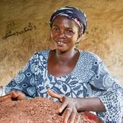 Damata Shihadu, 39, feeding ground shea nuts into pulper, Nyebu Be Yoona Shea Butter Processing Group, Kanfiehiyili village, Tamale, Ghana