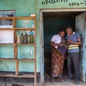 Two people smiling in doorway