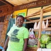 Cicily Makuma, a Kenyan farmer, standing in front of “Wanyawira Retail Shop”, her first venture in the retail business