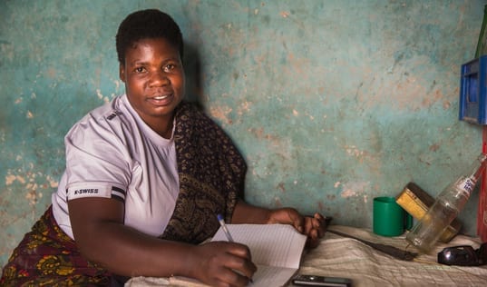 Tanzanian women with her successful mobile saving strategies