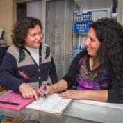 Two women smiling working together to build their business in Chile