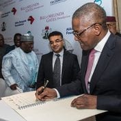 Man smiling at convention and signing book