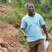 Man smiling working on a mountainside