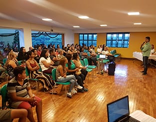 Speaker in front of room full of people