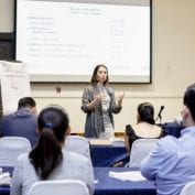 Woman teaching to a room full of people