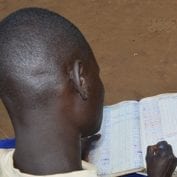 Smallholder farmer logging activity in book