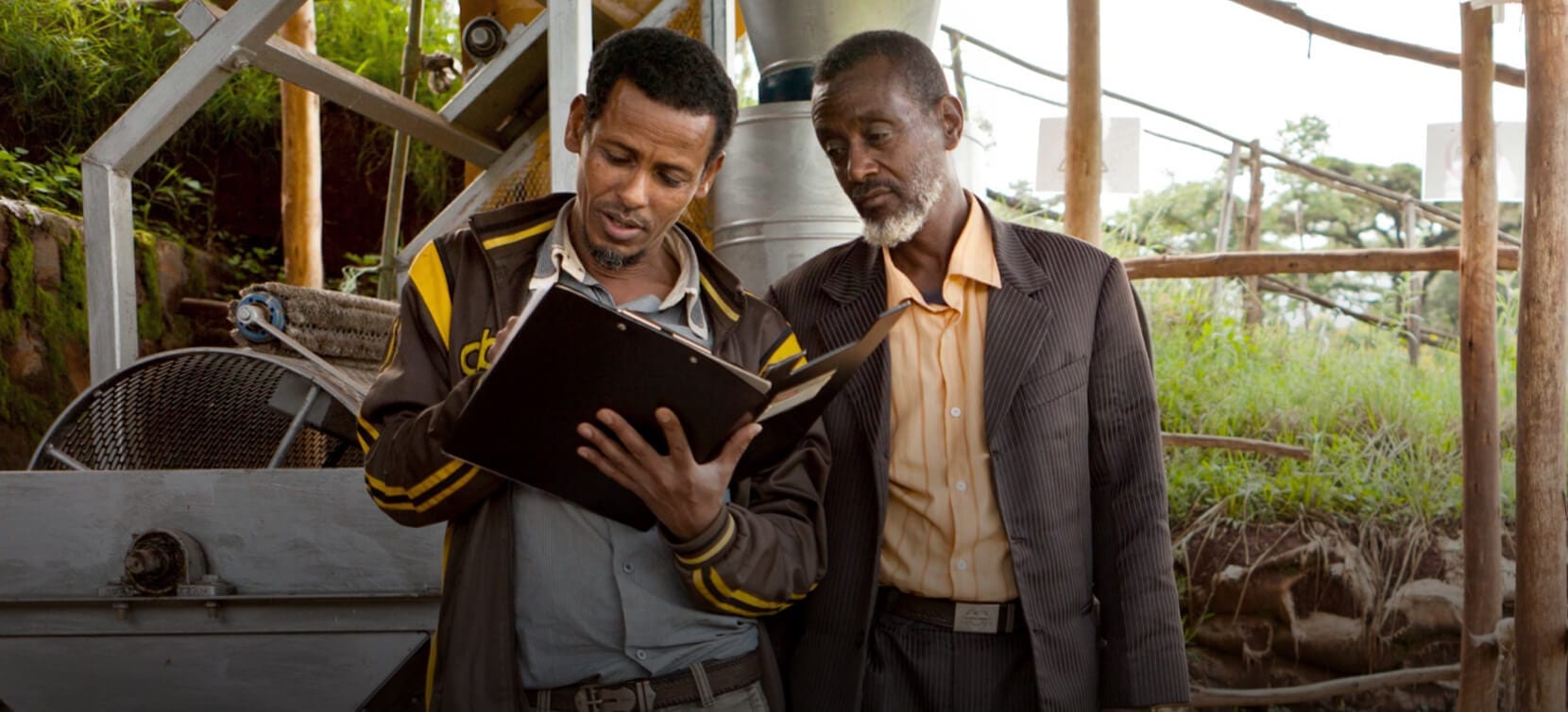 Two men working hard looking at chart