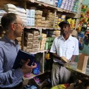 Two business men talking in a grocery store