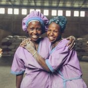 Women workers smiling at a grain mill in Sannie, Ethiopia