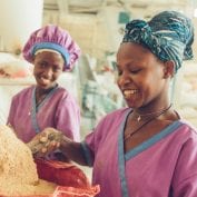 Two women smiling while working in Africa