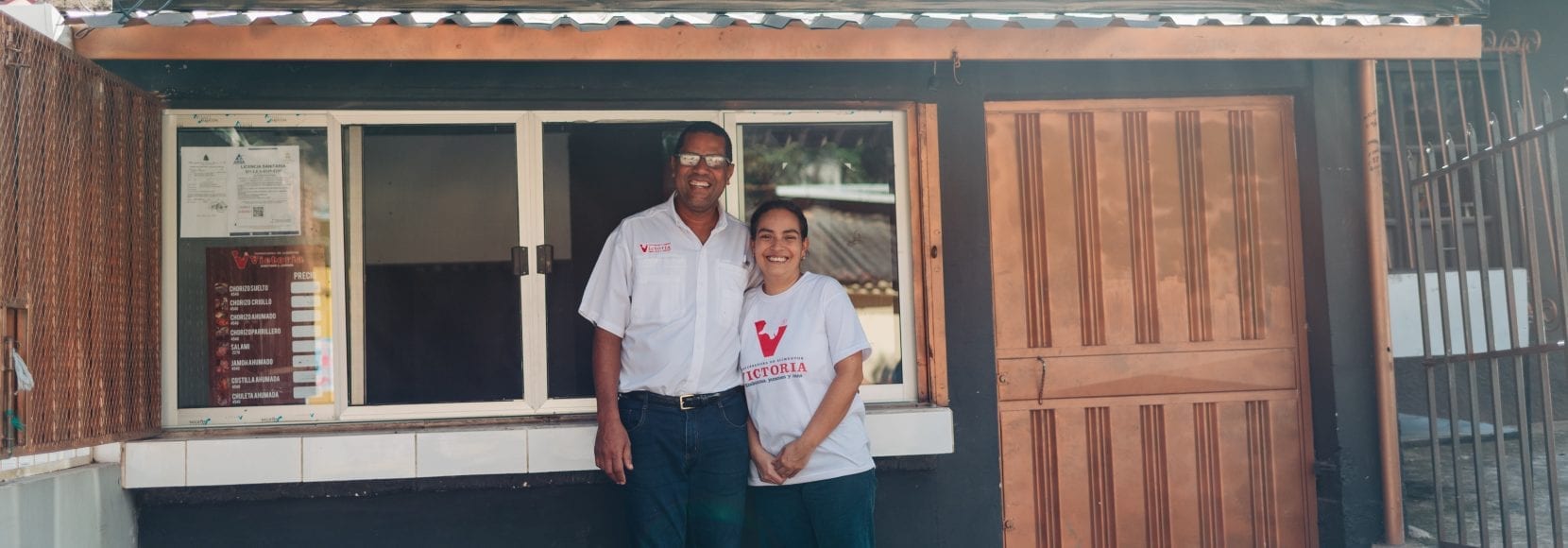 Couple standing in front of their store in Honduras