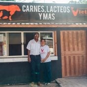 Couple standing in front of their store in Honduras