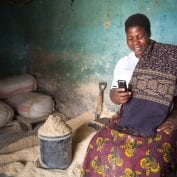 Woman smiling while looking at smartphone