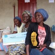 Three women in Benin smiling after receiving awards