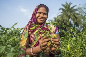 woman farmer in India shows her harvest