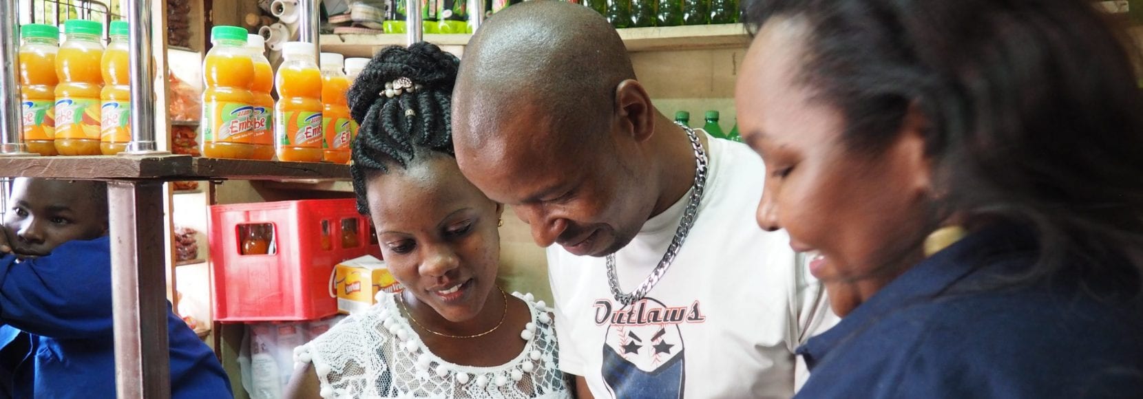 Group of people smiling watching a video on a phone