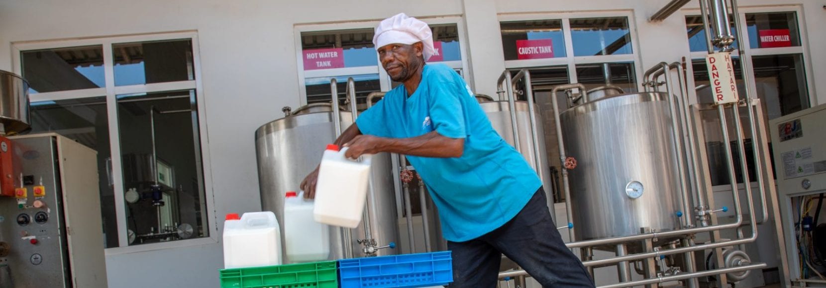 Man working on packaging milk