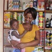 Bernadette Sambo stands in her shop in Mozambique.