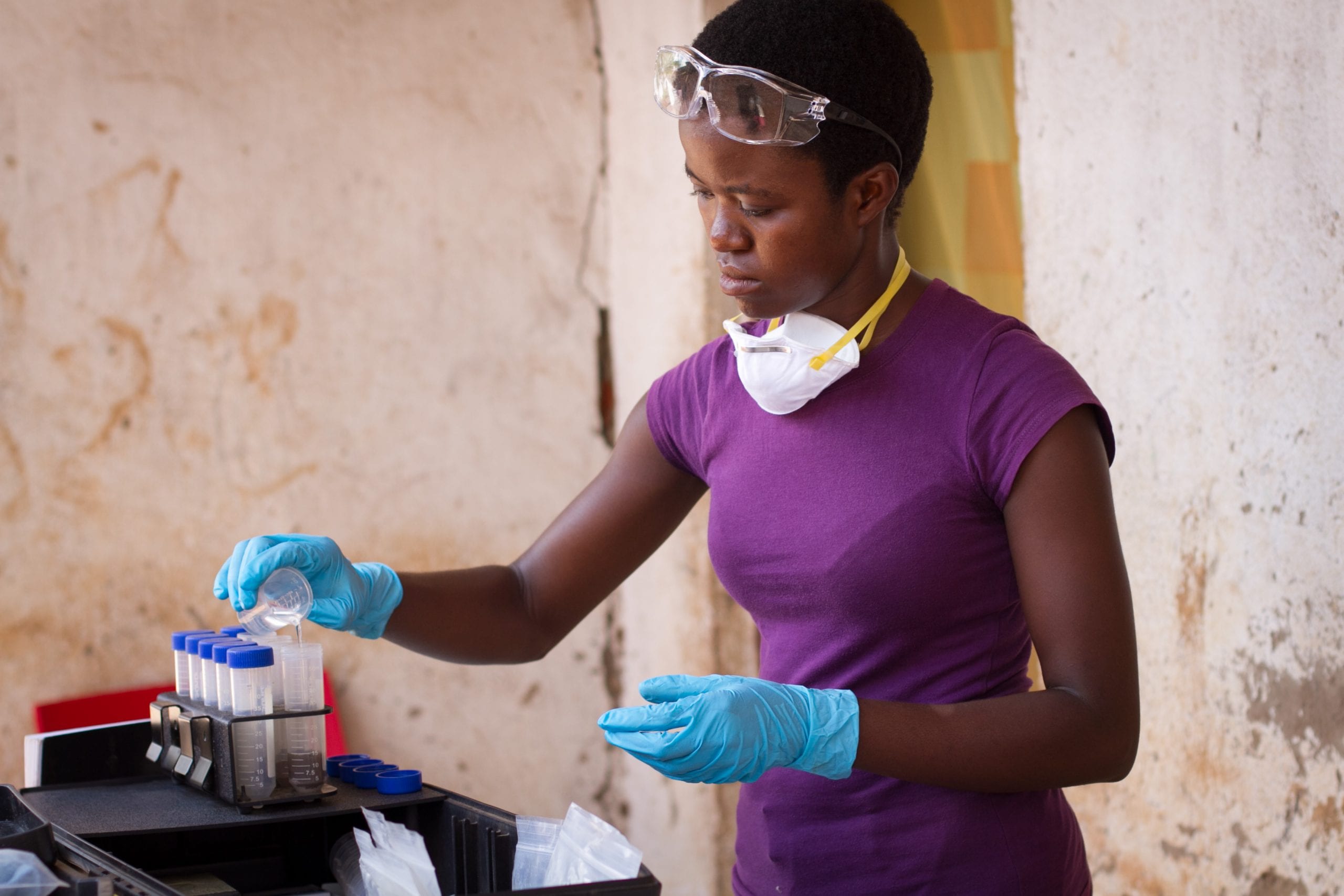 Woman pouring liquid into tubes
