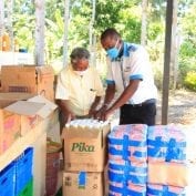 Two men packaging food for delivery