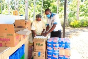 Two men packaging food for delivery