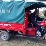 Man with motorcycle cart hauling food