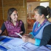 fighting poverty at TechnoServe looks like Two women smiling having a conversation in Chile