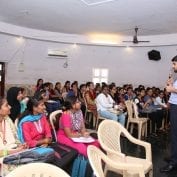 A group of young adults learning about formal work opportunities at a workshop in India