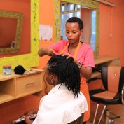 Carolyn works on a client in her salon business near Kampala, Uganda