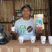 Cruz Juanan stands in his coffee shop in Peru