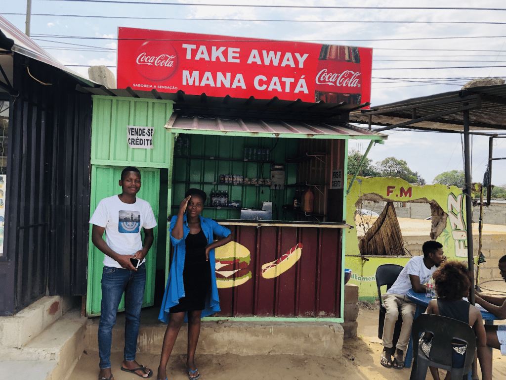 Catarina Bié stands outside her takeaway shop in Maputo, Mozambique. Small businesses play an essential role in the Mozambican economy.
