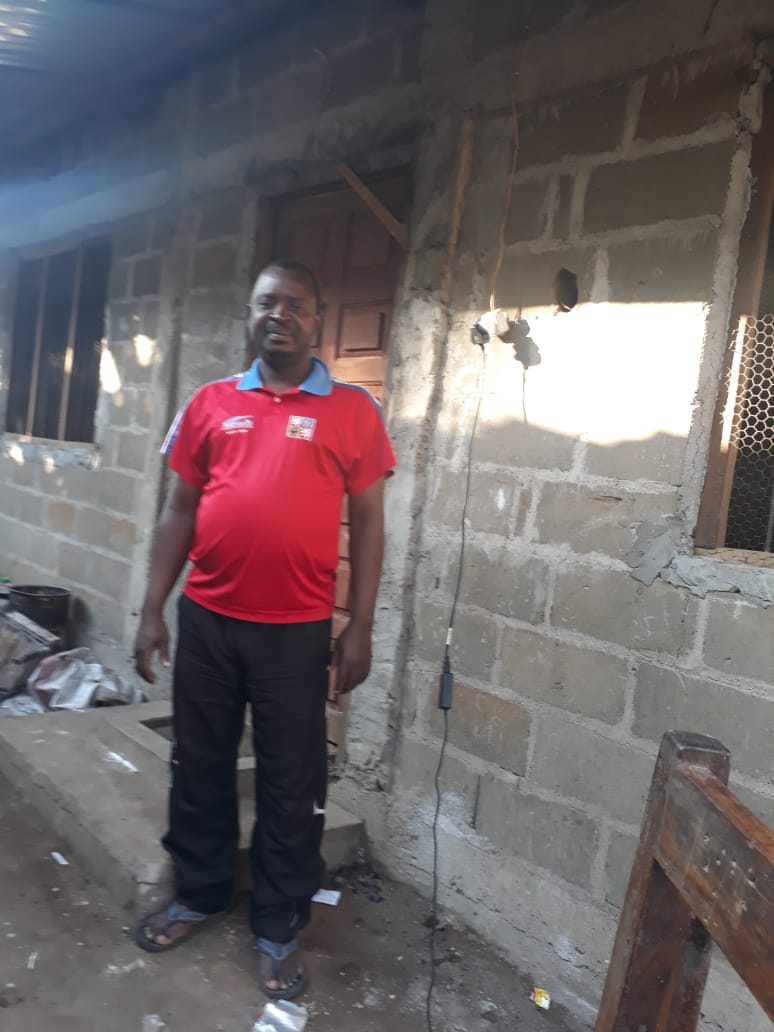 Amândio Cardoso stands outside his home in Pemba, Cabo Delgado, Mozambique.