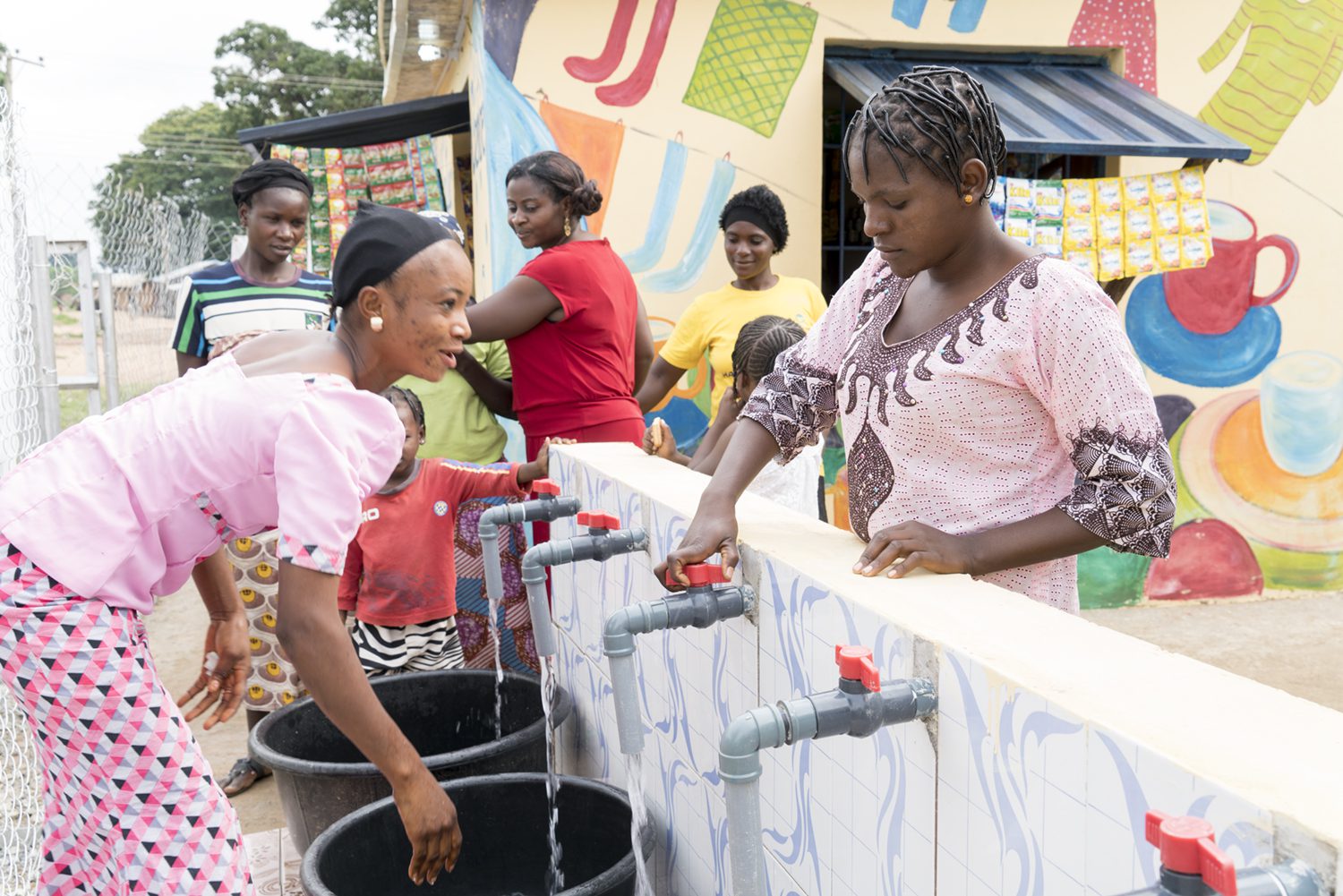 A group of women gather water in Nigeria, a form of unpaid care work and labor that often falls on women more often than men